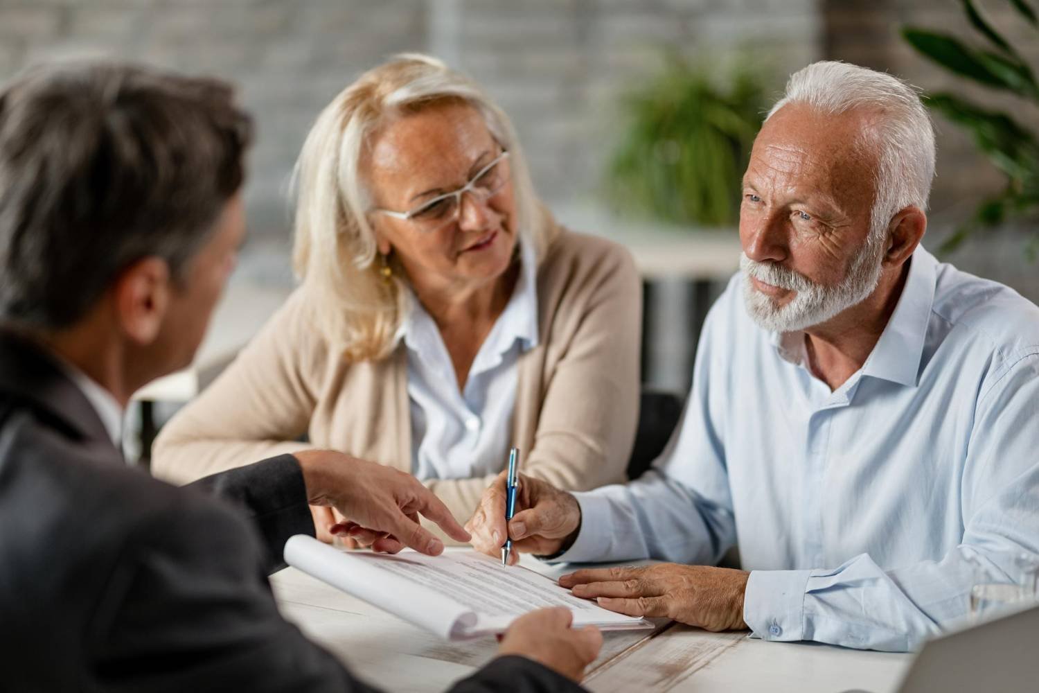 Mature couple having a meeting with insurance agent