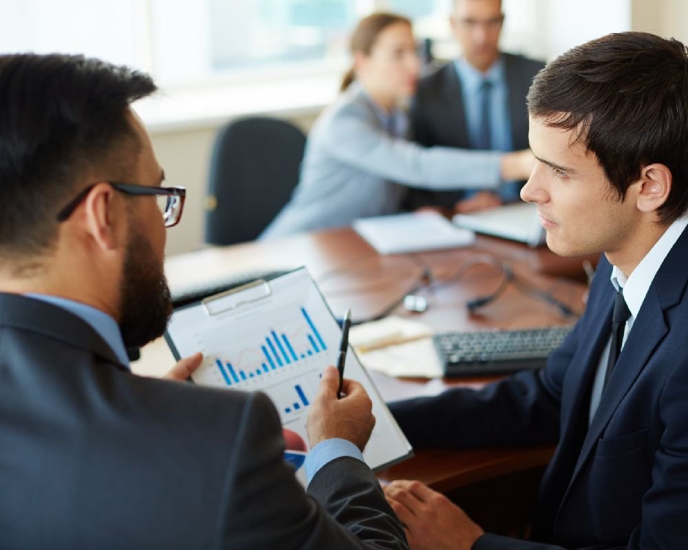two men discussing data